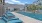 a pool with lounge chairs around it