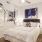 a bedroom with a large mirror