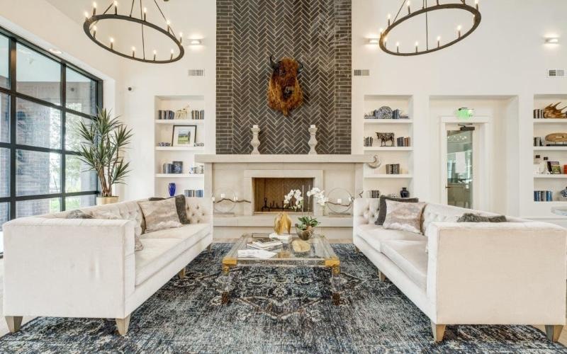 a clubhouse room with chandeliers and couches