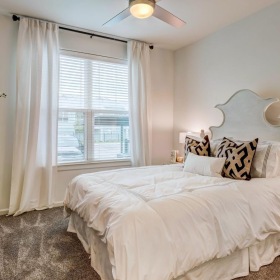 Generous bedroom offerings to fit every family a bedroom with a bed and a fan